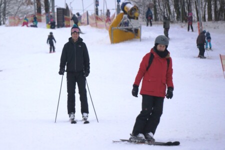 Two skiers going downhill
